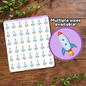 May include: A sheet of stickers with a repeating pattern of small, blue and red rocket ships. The sheet is labeled "Rocket Ships" and has the text "somethingpeaceful.com" at the bottom. A separate sticker with a larger rocket ship is shown in the upper right corner. The text "Multiple sizes available!" is written above the larger rocket ship sticker.