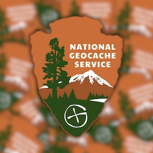 May include: An orange and green National Geocache Service logo. The logo is shaped like an arrowhead and features a tree, mountain, and the text "NATIONAL GEOCACHE SERVICE". A white circle with a crosshair design is at the bottom.