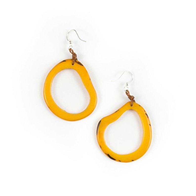 May include: A pair of yellow, organic-shaped earrings with a brown leather cord and silver hooks.