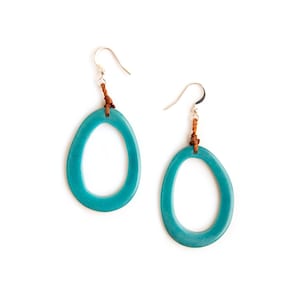 May include: Teal oval earrings with brown leather cord accents and silver hooks.