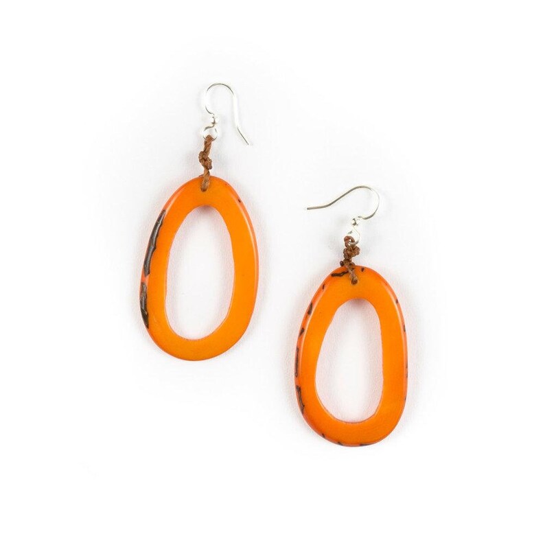 May include: A pair of orange oval-shaped earrings with a silver hook and brown string detail.