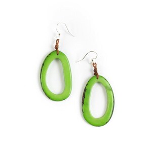 May include: A pair of green oval earrings with a brown leather cord and silver hooks.