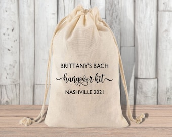 May include: A white drawstring bag with the text "Brittany's Bach hangover kit Nashville 2021" printed on it.