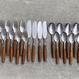 May include: A set of stainless steel cutlery with wooden handles. The set includes forks, spoons, and knives.