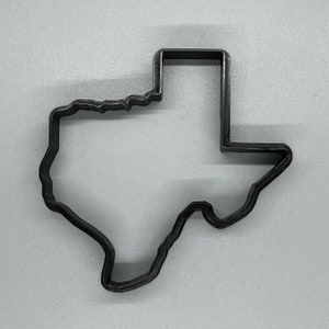 Könnte beinhalten: Schwarzer Plastik-Ausstecher in Form des Bundesstaates Texas.