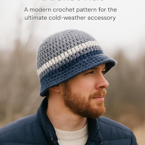 May include: A crochet bucket hat in shades of gray, white, and blue. The hat has a brim and a striped design. The text "Men's Cozy Winter Bucket Hat" and "Guide & Grind" are visible.