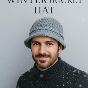 May include: A grey crochet bucket hat with a brim, worn by a person. The hat is part of a crochet pattern PDF. The image text reads: "MEN'S COZY WINTER BUCKET HAT" and "CROCHET PATTERN PDF DESIGNED BY GUIDE & GRIND."