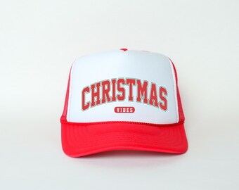 May include: A red and white trucker hat with the text "CHRISTMAS VIBES" in red letters with a green outline.