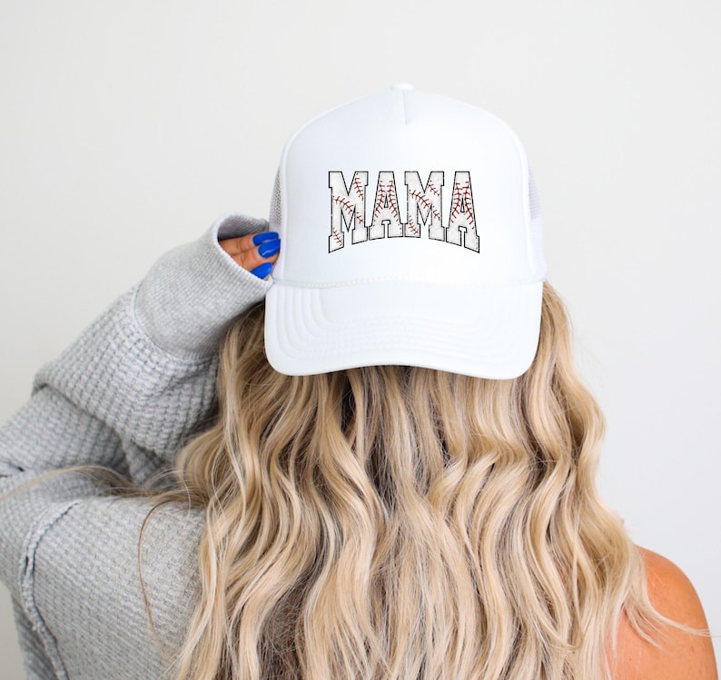 May include: White baseball cap with a black and red baseball graphic and the word "MAMA" in black letters.