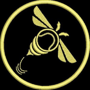 May include: A circular embroidered patch featuring a yellow bee design on a black background. The bee is stylised with a tennis ball as its body, yellow wings, and a stinger. The entire design is enclosed within a thick yellow circular border.