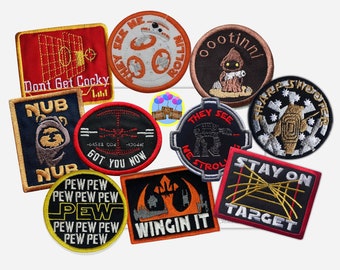 May include: A collection of embroidered patches featuring Star Wars characters and themes. The patches are colorful and feature various designs, including a TIE fighter, a Stormtrooper, and a quote from the movie.