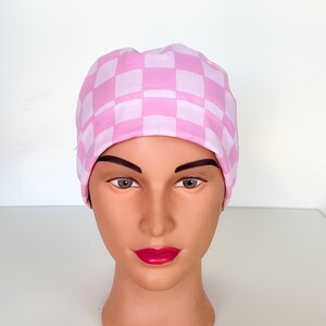 May include: A pink and white checkered scrub hat. The hat is made of a soft, comfortable fabric and is perfect for nurses, doctors, and other healthcare professionals.