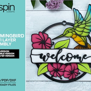 May include: A multi-layered wooden welcome sign featuring a hummingbird, flowers, and the word "welcome". The sign is designed for laser cutting and comes in assemble, non-assemble, and simple 2-layer versions.