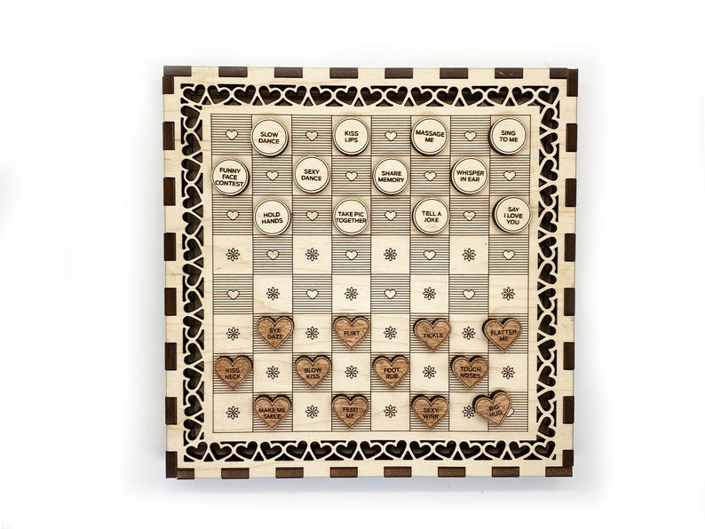 May include: A wooden game board with a checkered pattern and hearts around the edge. The board has small wooden hearts with phrases like "Kiss Neck", "Slow Dance", and "Say I Love You" on them.