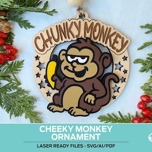 May include: A wooden ornament featuring a cartoon monkey holding a banana. The ornament has the text "CHUNKY MONKEY" and is surrounded by a circle with star cutouts. The ornament is brown, tan, yellow, and black. The text "CHEEKY MONKEY ORNAMENT" is at the bottom.