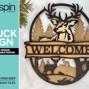 May include: A wooden sign with a deer silhouette and the word "WELCOME" in a black font. The sign is surrounded by a brown wooden frame and features a forest scene with trees and a deer in the background.