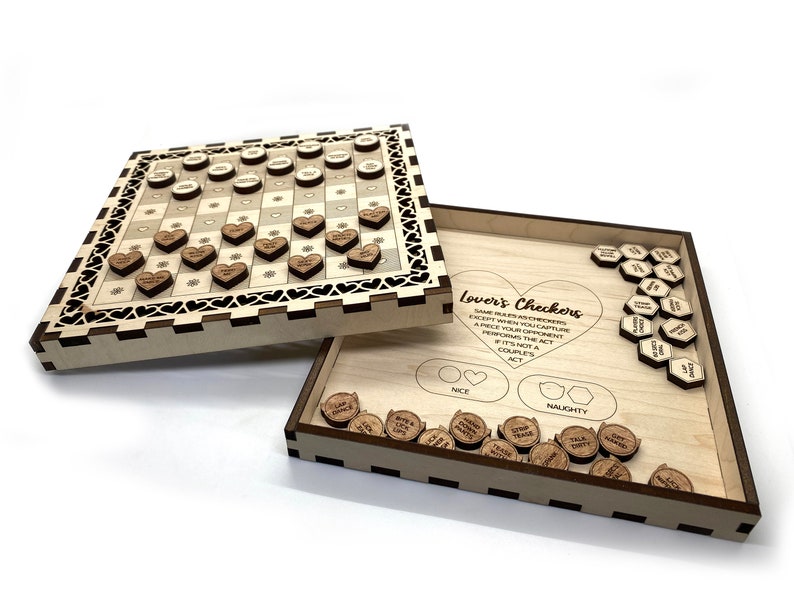 May include: A wooden game board with a checkerboard pattern and heart-shaped pieces. The board is open to reveal a set of wooden tokens with phrases like "Give Good Luck" and "Talk Dirty". The game is called "Lover's Checkers" and the rules are printed on the board.