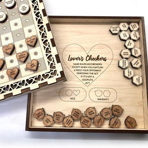 May include: A wooden game board with a checkerboard pattern and heart-shaped pieces. The game is called "Lover's Checkers" and the pieces have phrases like "Foot Rub" and "Say I Love You".