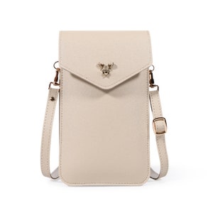 May include: A beige leather crossbody phone bag with a gold deer charm. The bag has a flap closure and a long adjustable strap.