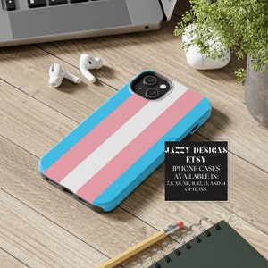 May include: A blue, pink and white iPhone case with a transgender pride flag design. The case is available in sizes 7, 8, XS, XR, 11, 12, 13 and 14. JAZZY DESIGNS ETSY IPHONE CASES AVAILABLE IN: 7, 8, XS, XR, 11, 12, 13, AND 14 OPTIONS.