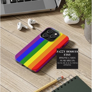 May include: A rainbow-colored iPhone case with a purple, blue, green, yellow, orange, and red design. The case is for an iPhone with a camera bump. The text on the case reads "Jazzy Designs Etsy iPhone Cases Available in: 7, 8, XS, XR, 11, 12, 13, and 14 options."