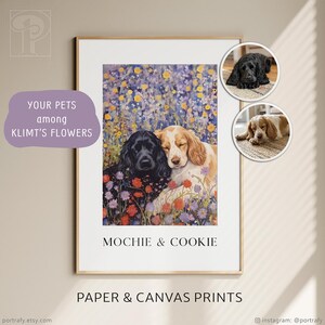 May include: A framed print featuring two dogs, one black and one tan, nestled together amidst a field of colorful flowers. The text "MOCHIE & COOKIE" is displayed below the image, with the words "PAPER & CANVAS PRINTS" at the bottom.