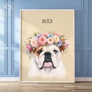 May include: A framed portrait of a bulldog wearing a floral crown. The dog has a white and brown coat, with the name "Butch" above. The background is a light yellow color.