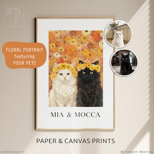 May include: A framed print featuring two cats, one white and one black, adorned with floral crowns. The background is a blend of orange and yellow flowers. Text on the print reads "MIA & MOCCA" and "PAPER & CANVAS PRINTS."