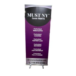 May include: A retractable banner with the text "MUST NY Custom PRINTS" in white on a black and purple background. The banner lists services including customized tablecloths, canopies, feather flags, backdrops, step and repeat, and pull-up banners. The website and phone number are also displayed.