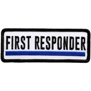 May include: Embroidered patch with the words "FIRST RESPONDER" in black capital letters above a blue horizontal stripe. The patch has a white background with a black border.