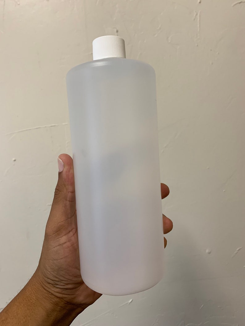 May include: A clear plastic bottle with a white cap. The bottle is empty and appears to be made of a durable material.