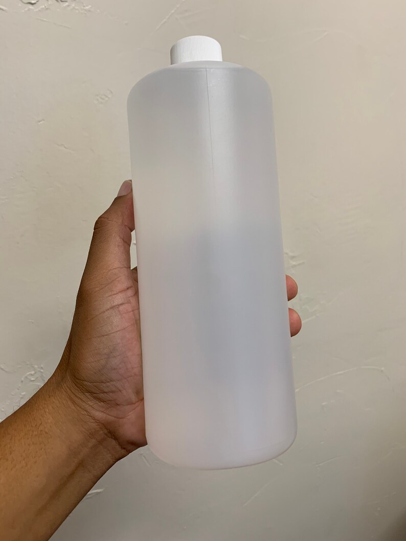 May include: A clear plastic bottle with a white cap. The bottle is empty and has a smooth, cylindrical shape.