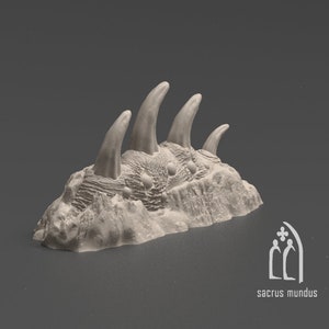 May include: A 3D printed model of a rocky terrain with several sharp, pointed spikes protruding from the surface. The model is made of a light gray material and has a rough, textured surface.