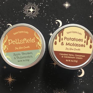 May include: Two round soy wax candles in metal tins. One is labeled "Pottsfield" with "Apple, Bourbon & Butterscotch" and the other is labeled "Potatoes & Molasses" with "Candied Yams, Cinnamon & Cardamom Cream". Each candle is 4oz (113g).