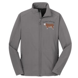 May include: A gray soft-shell jacket with a zipper closure and two zippered pockets. The jacket has an embroidered image of a brown and white cow with the text "Custom Lettering" above it.