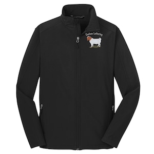May include: A black long-sleeve soft shell jacket with a full-length front zipper and a stand-up collar. The left chest features an embroidered graphic of a white and brown goat standing above the text Custom Lettering in a white font.