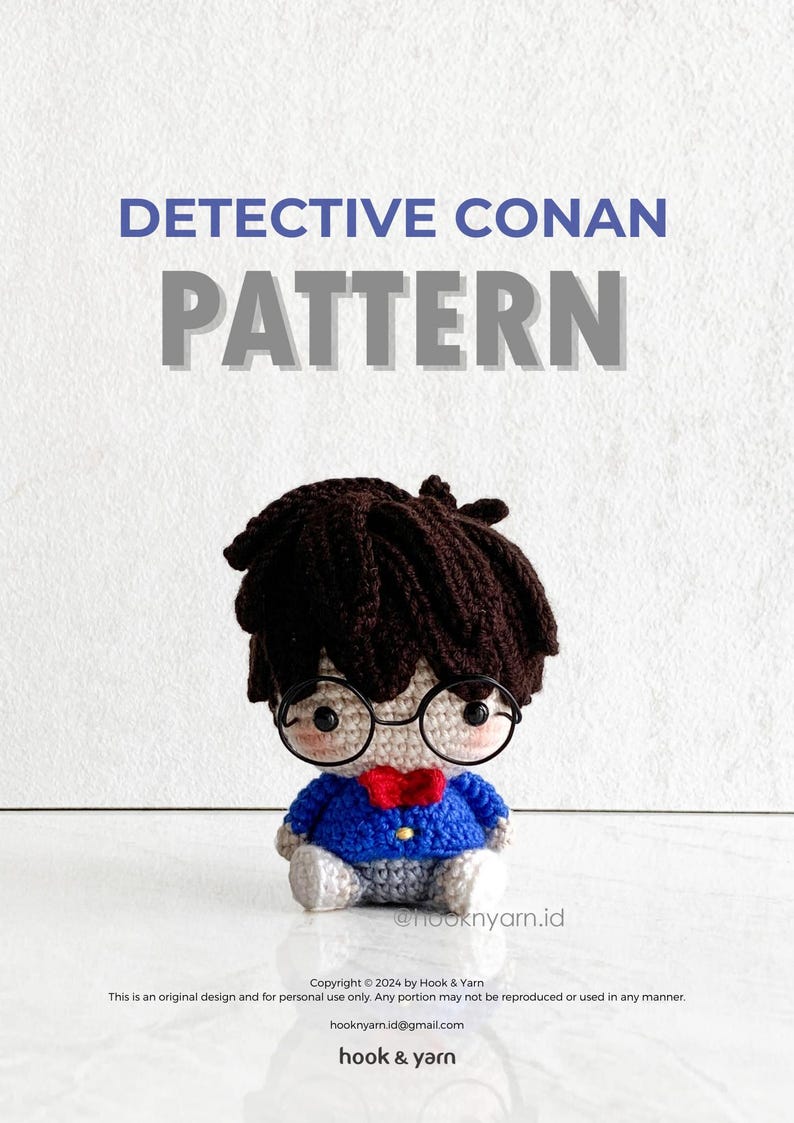 May include: Crochet pattern for a Detective Conan amigurumi doll. The doll is wearing a blue jacket, a red bow tie, and glasses. The pattern is available for download.