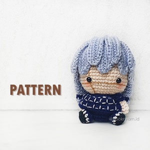 May include: A crocheted amigurumi doll with blue hair, a blue and white checkered shirt, and black shoes. The doll is sitting on a white surface. The text "PATTERN" is in brown letters at the bottom left of the image. The text "@hookryarn.id" is in black letters at the bottom right of the image.