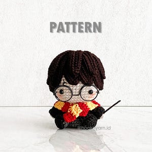 May include: Crocheted amigurumi doll of Harry Potter with black hair, round glasses, and a red and yellow scarf. The doll is holding a wand. The text "PATTERN" is above the doll and "@hookyarn.id" is below the doll.