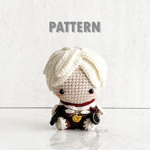 May include: Crochet pattern for a white-haired amigurumi doll wearing a red and brown outfit. The doll has a sweet expression and is holding a small object in each hand.