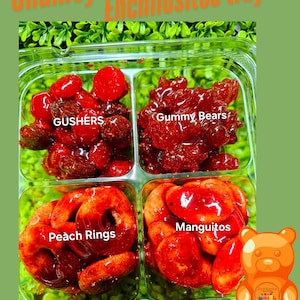 May include: A clear plastic tray filled with four different types of red, sweet, and spicy Mexican candy. The tray is divided into four sections, each labeled with a different type of candy: Gushers, Gummy Bears, Peach Rings, and Mangitos. A cartoon gummy bear is in the lower right corner of the image.
