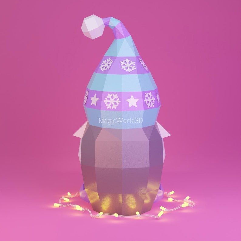 May include: A geometric paper snowman wearing a light blue and purple hat decorated with snowflakes and stars. The snowman is surrounded by a string of yellow lights, set against a pink background. The text "MagicWorld3D" is visible.