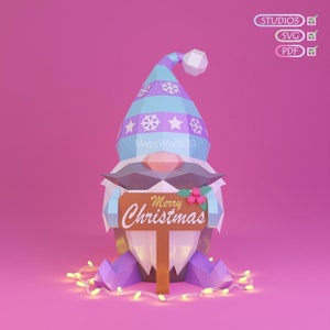 May include: A geometric Christmas gnome with a blue and purple hat, holding a sign that says "Merry Christmas." The gnome has a white beard and mustache, with a string of lights at its feet. The background is pink.