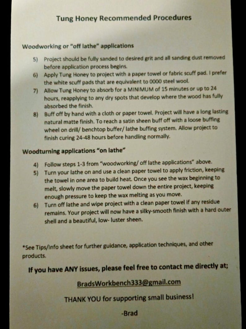 May include: A white sheet of paper with black text outlining recommended procedures for using Tung Honey wood finish. The text includes instructions for woodworking and woodturning applications, as well as contact information for the seller.