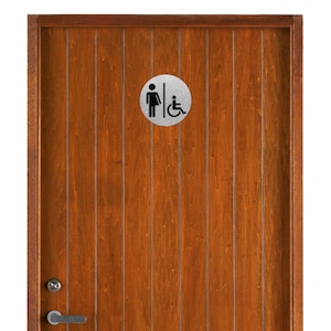 May include: A brown wooden door with a silver round sign that has a female symbol and a wheelchair symbol.