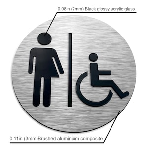 May include: A round, brushed aluminum sign with black glossy acrylic glass symbols. The sign features a gender-neutral restroom symbol and a wheelchair accessibility symbol. The sign measures 0.11 inches (3 mm) thick and 0.08 inches (2 mm) thick.