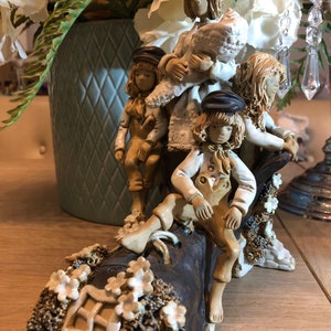 Old mother Hubbard lived in the shoe figurine . Hand made and painted pottery ornament