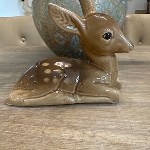 Deer fawn sitting retro