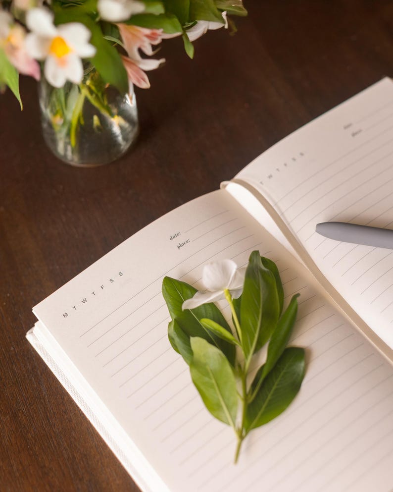 The image shows a church notebook opened to show blank lined pages with a space for "date" and "place" at the top as well as MTWTFSS for the writer to circle.