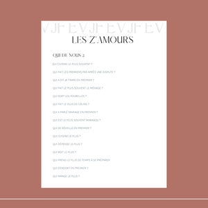 May include: A white sheet of paper with the text "LES Z'AMOURS" in black at the top. Below the title is a list of questions in French, such as "Qui cuisine le plus souvent?" and "Qui fait les premiers pas apr&egrave;s une dispute?"